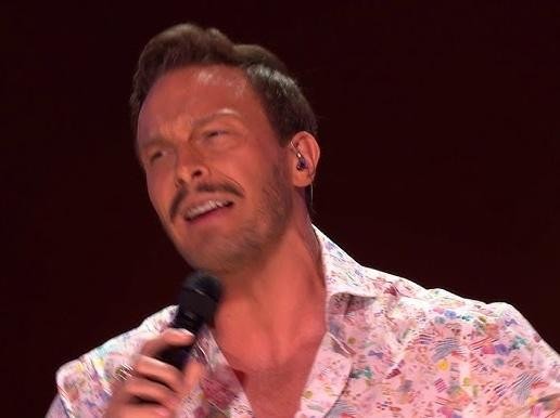 Młody Sławek Uniatowski grający na instrumencie klawiszowym, ukazujący jego wczesne lata muzycznej pasji.