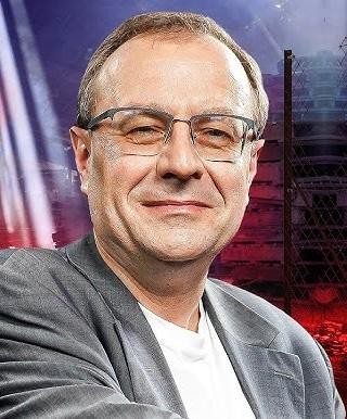 Antoni Dudek podczas wykładu lub wystąpienia medialnego, z ekspresją i zaangażowaniem prezentujący zagadnienia historyczne lub polityczne.